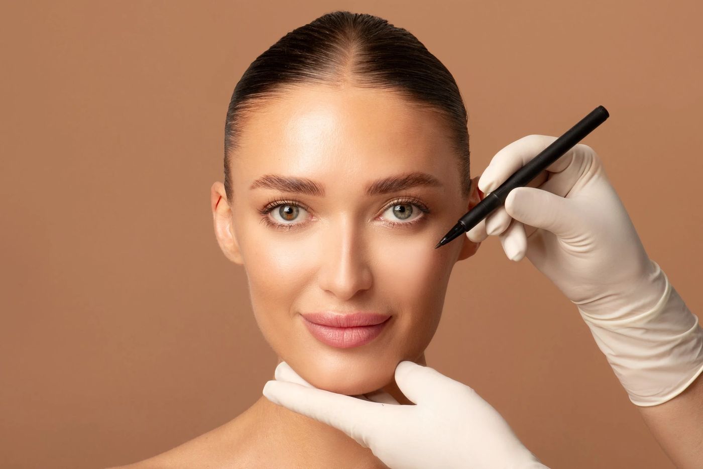 Clinician gently assessing the face during a consultation