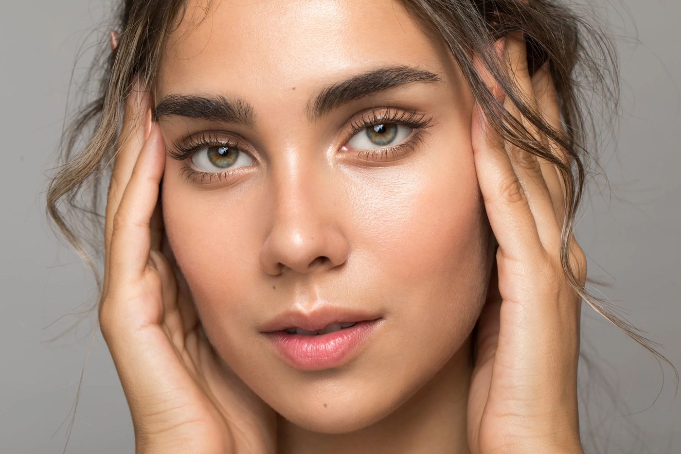 Close portrait of a woman with hydrated, healthy-looking skin